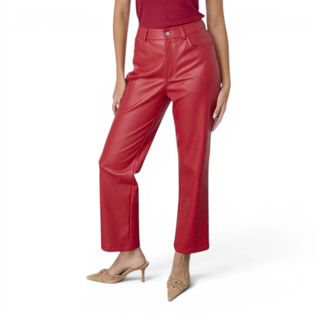 Women’s high-waisted red leather pants styled as bold statement leather trousers for luxury fashion outfits.