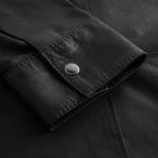 Women’s black leather overshirt with structured shape and smooth leather finish