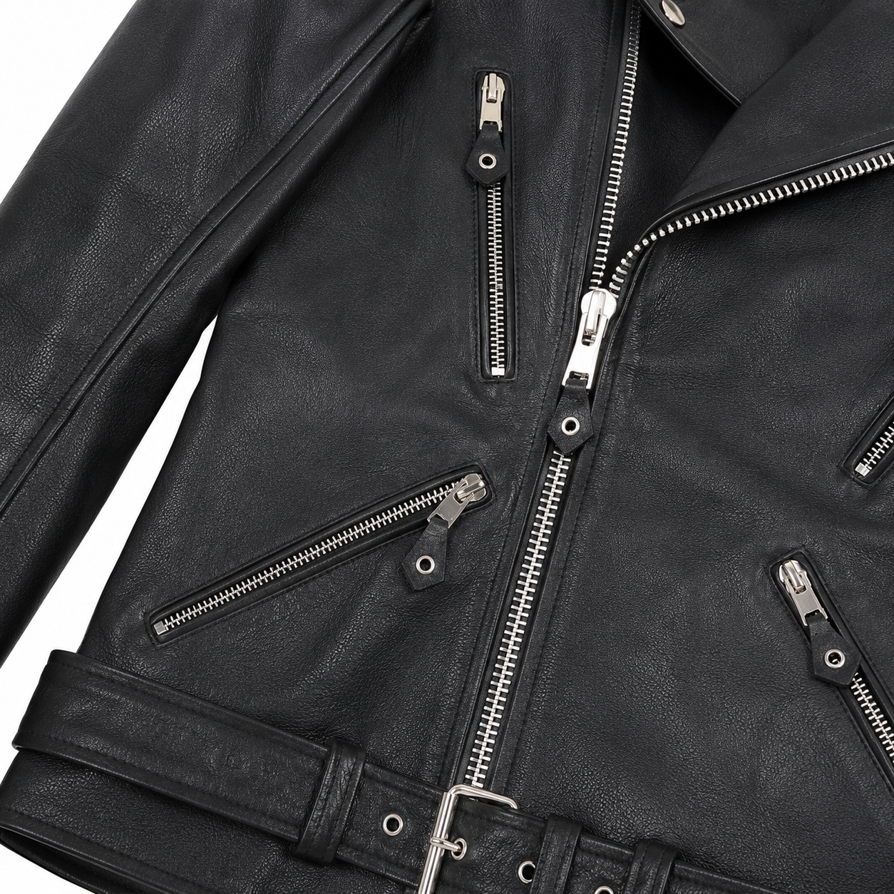 Close-up of black leather biker jacket showing silver zippers, textured leather, pocket details and waist buckle