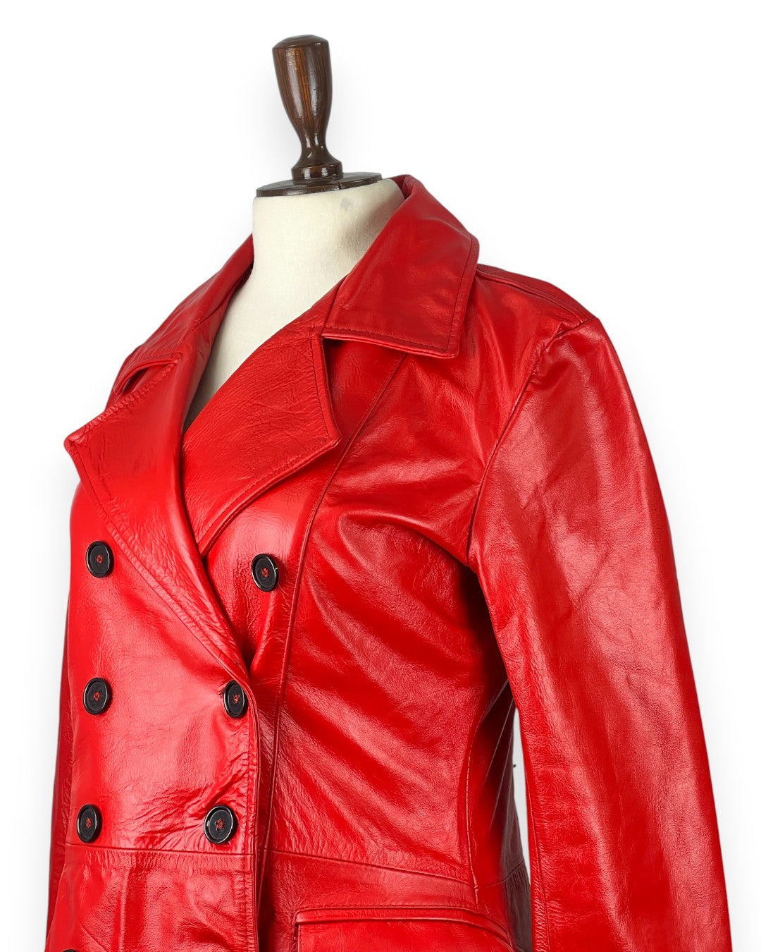Double-breasted red leather coat for women with bold military look and premium outerwear appeal.
