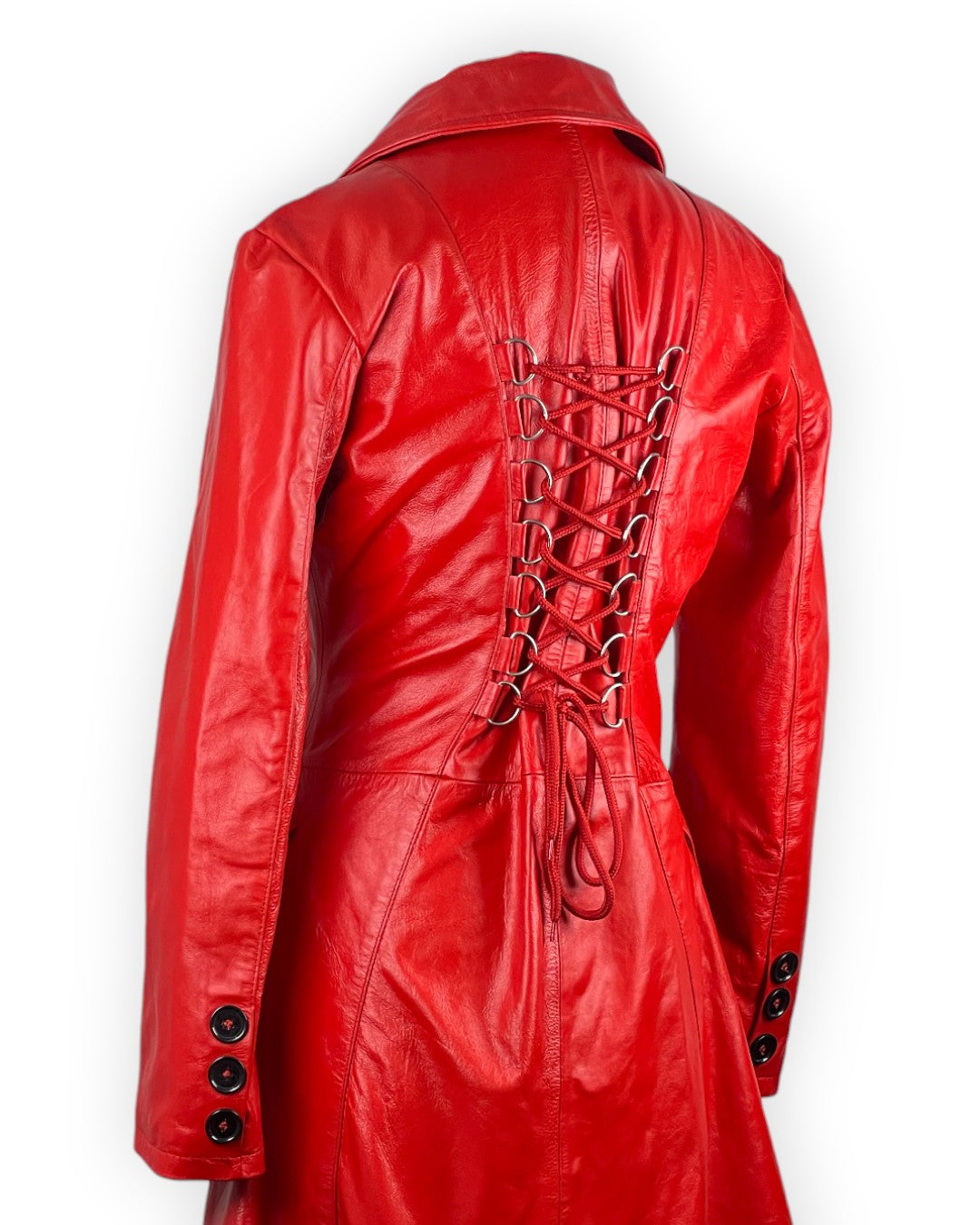Red leather trench coat for women with double-breasted closure, tailored fit and bold luxury fashion look.
