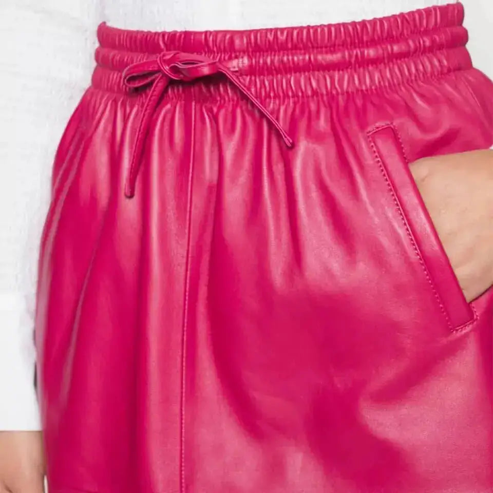 Pink leather skirt for women with midi length and clean premium fashion silhouette.