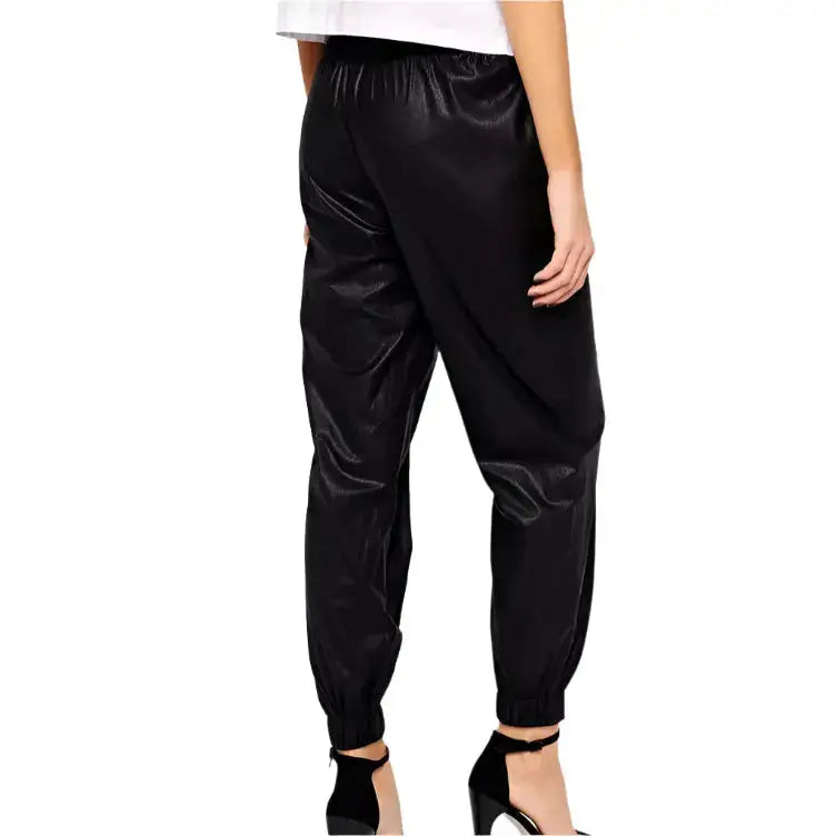 Women’s black leather pants in jogger style with comfortable fit and premium urban fashion design.