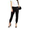 Women’s black leather joggers with relaxed fit, premium leather finish and modern streetwear pants style.